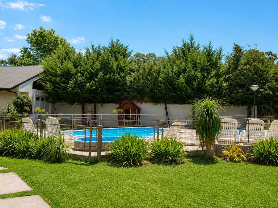 Pool among the trees at Complejo Arami Apart