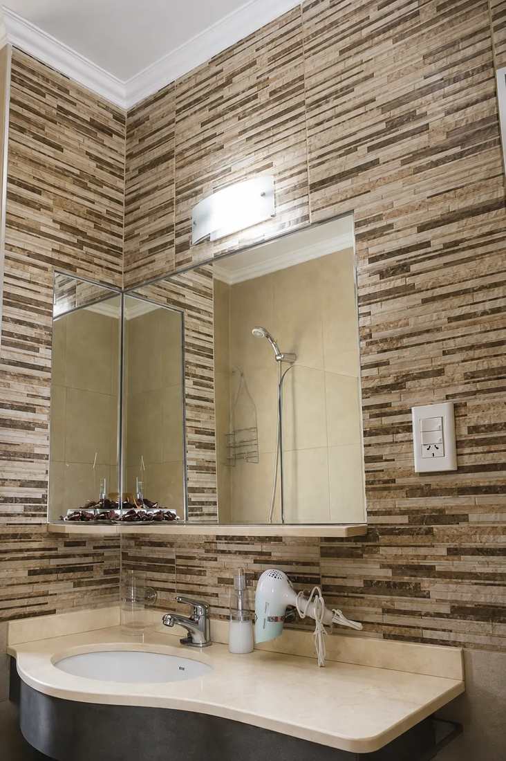 Private tiled bathroom with large mirror